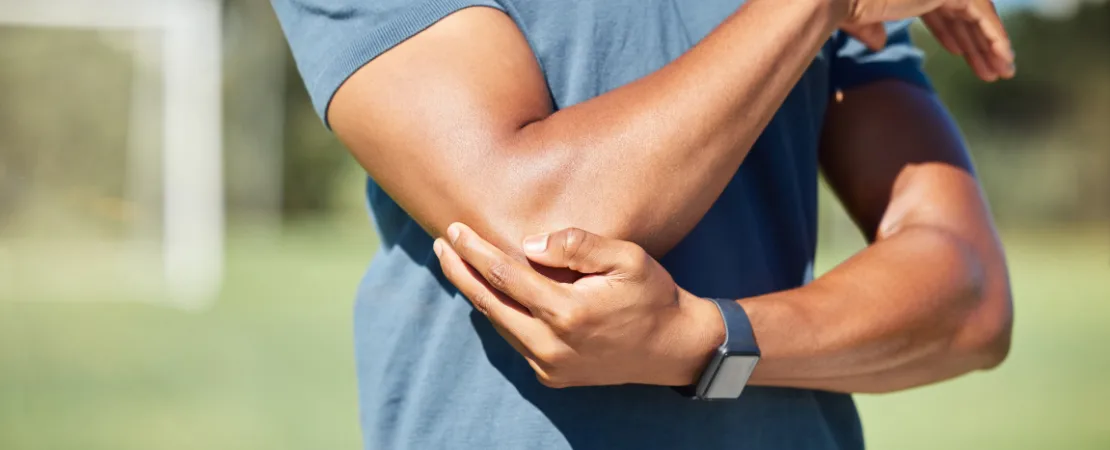 Physiotherapist at Physiocare Ottawa performing manual elbow therapy on a patient with an MCL ligament sprain